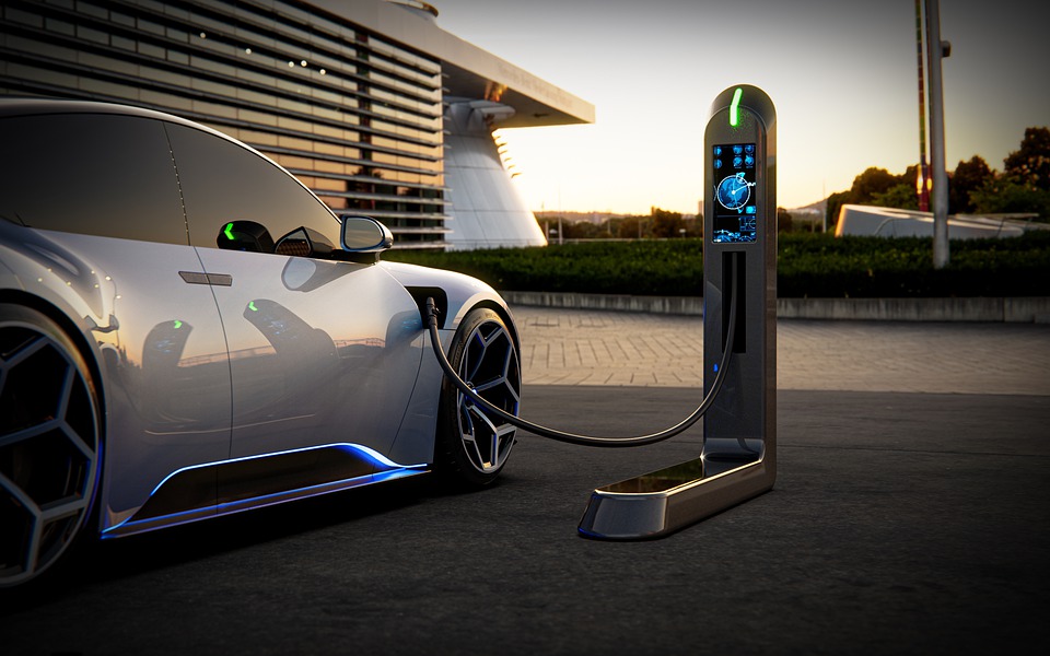 An electric vehicle sits plugged in at its charging station.